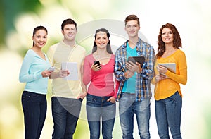 Group of teenagers with smartphones and tablet pc