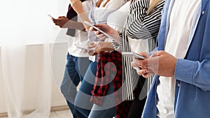 Group of Teenagers Standing Holding Cell Phones, Copy Space