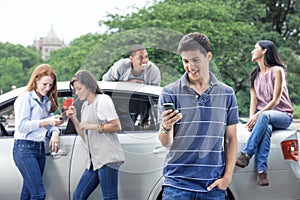 Group of teens with car