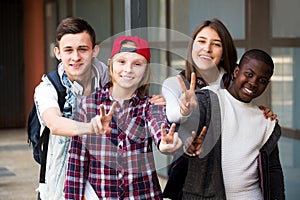 Group of teens posing outside school