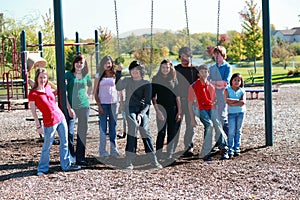 Group of teens on swingset photo