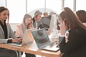 Group of telemarketing employees work in the office