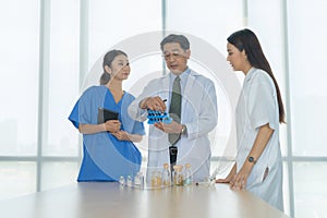 Group of Thai Asian doctors with medicine, medical team having a meeting, brainstorming conference call in hospital. Discussing