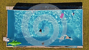 Group of three children enjoying outdoor time in a beautiful pool