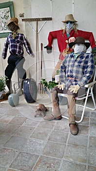 Scarecrow figures arranged in indoor setting