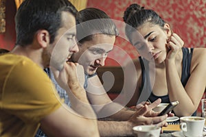 Group of three friends in a coffee shop