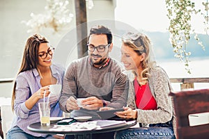 Group of three friends having fun a coffee together.