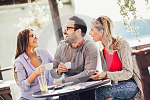 Group of three friends having fun a coffee together.