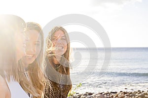 Group of three girls walking on a wall near the beach