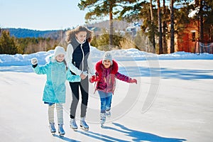 A group of three girls on a winter skating rink. Roll and laugh.