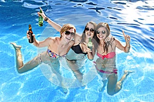 Group of three happy girl friends having bath in swimming pool t