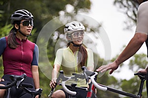 young asian cyclists chatting outdoors photo