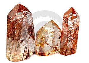 Group of three Mineral quartz rocks with rutile isolated on a white background
