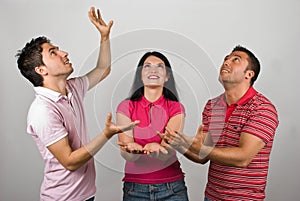 Group of three people catching something