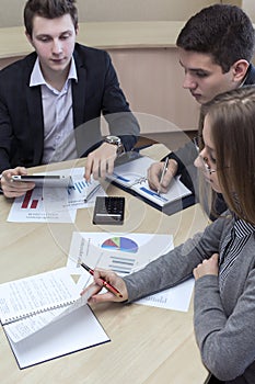 Group of three people having discussion