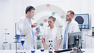 Group of three scientists in modern laboratory