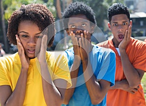 Group of three shocked african american young adults