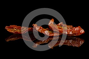 Dry red cherry tomato isolated on black glass