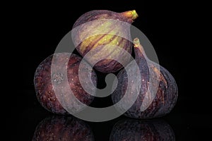 Fresh fig fruit isolated on black glass