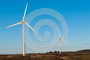 A group of three wind turbines in a wind farm