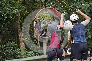 young asian cyclists taking a selfie on rural road photo