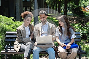 Group of three young business people experts in marketing telecommuting financial and strategy, talking outside office building.