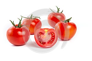 a group of tomatoes on a white background, with shadows. One tomato cut, studio photo, isolate, tomatoes washed