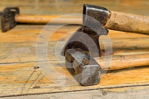 Group of tools heavy metal hammer and ax lies on the background of wooden planks