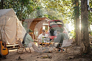 Group tourists drinking beer-alcohol and play guitar together with enjoy and happiness in Summer while camping