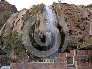 A group of tourists enjoy the hot spring cascade bathing facility at Hammamat Ma`In Hot Springs, Jordan