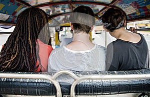 Group of tourists enjoy tuk tuk native taxi drive