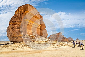 Arab man in front of Tomb of Lihyan, son of Kuza carved in rock in the desert, Mada\'in Salih, Hegra photo