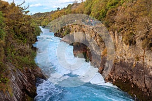 Group of tourists looking at Huka Falls on the Waikato River in
