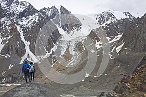 Group of tourists  the man and woman goes to mountains glacier Actru Russia