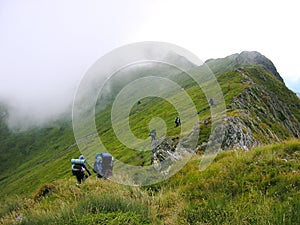 A Group Of Tourists On A Mountain Ridge