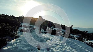 A group of tourists travels through the snow-capped mountains