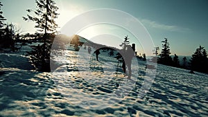 A group of tourists travels through the snow-capped mountains