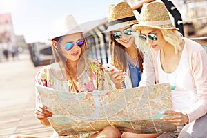 Group of tourists using map in the city