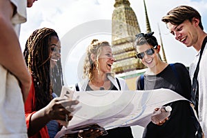 Group of tourists using the map in Thai temple