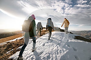 Group of tourists walks on mountain top