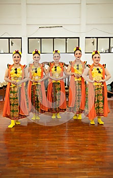 a group of traditional Sundanese dancers standing with their friends before the performance starts