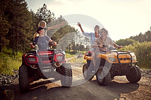 Group of traveler friends driving quads photo