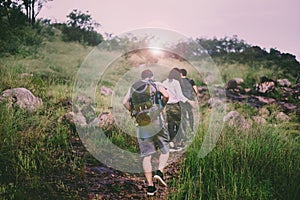 Group of traveler friends walking together at rain forest,Enjoying backpacking concept,Back view