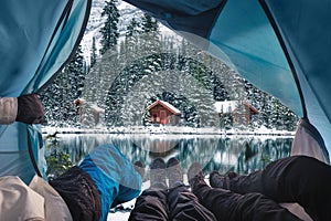 Group of traveler opening tent with wooden lodge in snow forest on Lake O`hara at Yoho national park