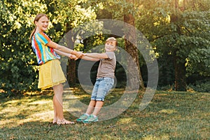 Group of two children playing together in summer park