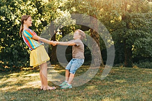 Group of two children playing together in summer park