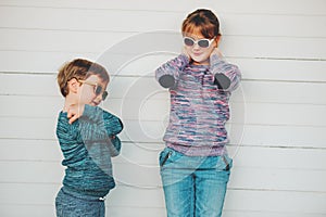 Group of two funny kids playing together outside