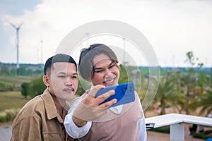 Group of two LGBTQ friends sitting and chatting and taking pictures. Along with laughing happily on the roof of the coffee shop