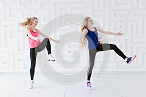 Group of two young women dancers dancing in the studio