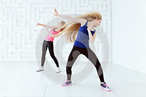 Group of two young women doing a fitness dance workout